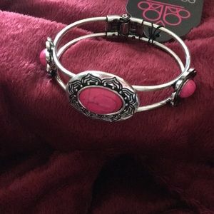 A silver and pink bracelet never been worn before